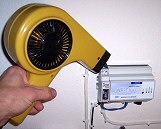 A hairdryer is used to "trigger" the shrinking of the covers for the electrical connections on the kWh meter.