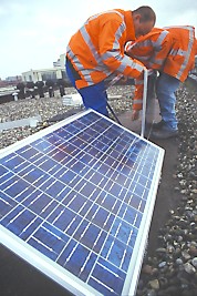 chilly job assembling an aluminium frame support for a solar panel on windy, cold day in March